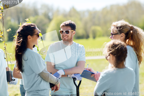 Image of group of volunteers planting trees in park