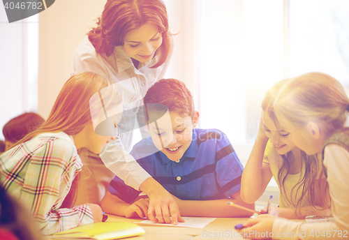 Image of group of school kids writing test in classroom