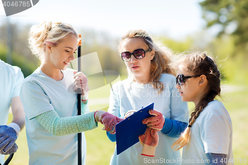 Image of group of volunteers with clipboard in park