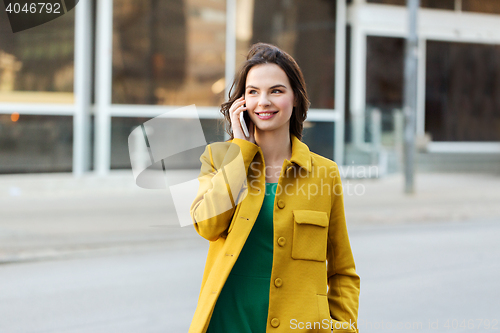 Image of smiling young woman or girl calling on smartphone