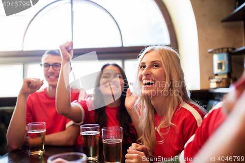 Image of football fans or friends with beer at sport bar