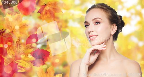 Image of beautiful young woman touching her face