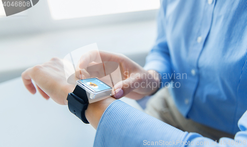 Image of close up of hands with music player on smart watch