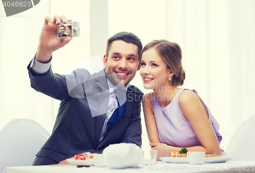 Image of smiling couple taking self portrait picture