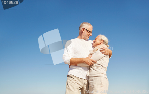 Image of happy senior couple talking outdoors