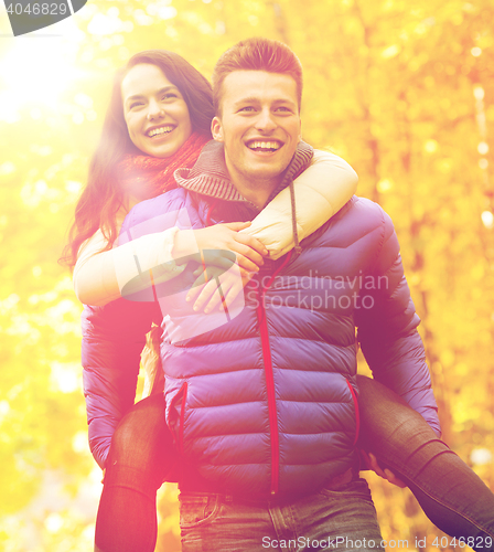 Image of smiling friends having fun in autumn park