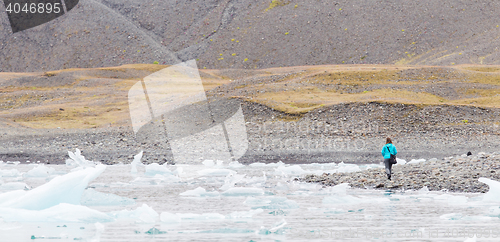 Image of Woman walking over the beach at Jokulsarlon glacier lagoon - Ice