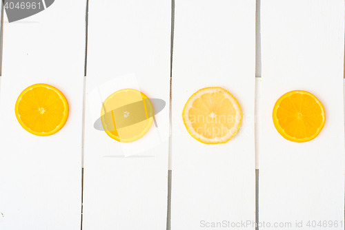 Image of Colorful citrus fruits on the rustic white background.