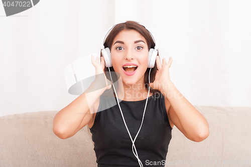 Image of Woman listening music in headphones