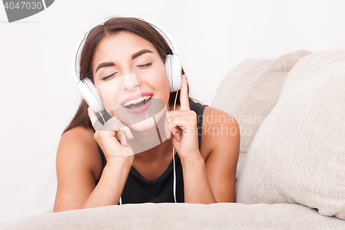 Image of Woman listening music in headphones