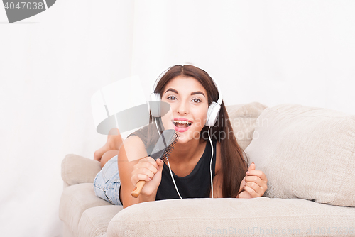 Image of Woman listening music in headphones