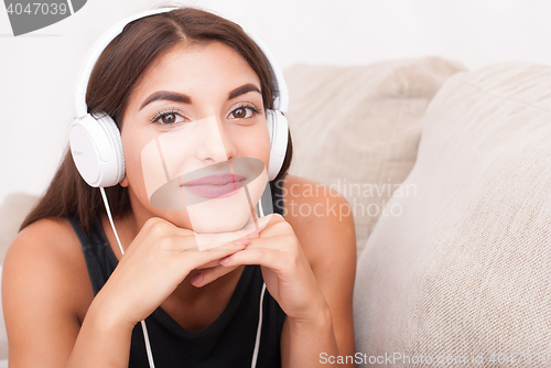 Image of Woman listening music in headphones