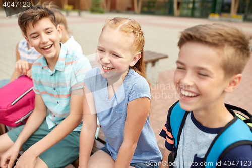 Image of group of happy elementary school students talking