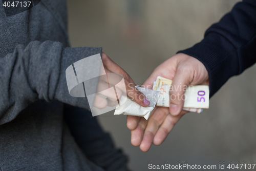 Image of close up of addict buying dose from drug dealer