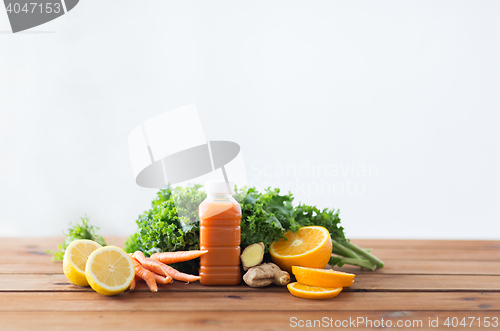 Image of bottle with carrot juice, fruits and vegetables