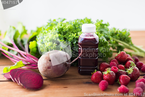 Image of bottle with beetroot juice, fruits and vegetables