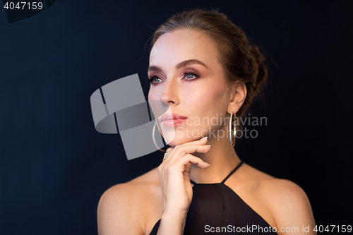 Image of beautiful woman in black wearing diamond jewelry