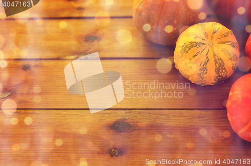 Image of close up of pumpkins on wooden table at home