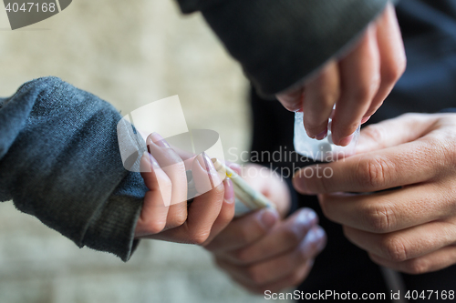 Image of close up of addict buying dose from drug dealer