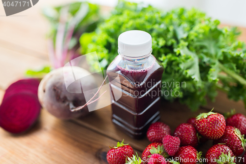 Image of bottle with beetroot juice, fruits and vegetables