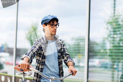 Image of hipster man walking with fixed gear bike