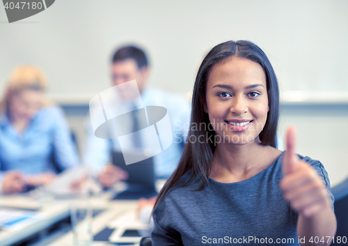 Image of group of smiling businesspeople meeting in office