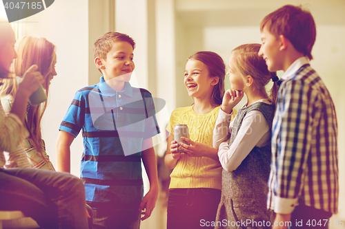 Image of group of school kids with soda cans in corridor