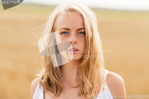 Image of young woman in white on cereal field