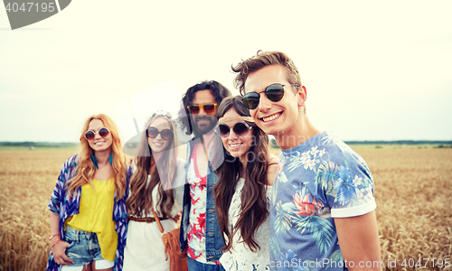 Image of smiling young hippie friends on cereal field