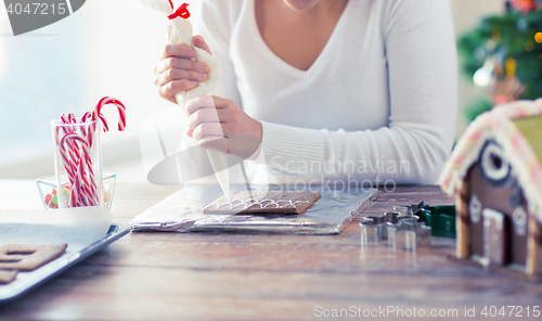 Image of close up of woman making gingerbread houses