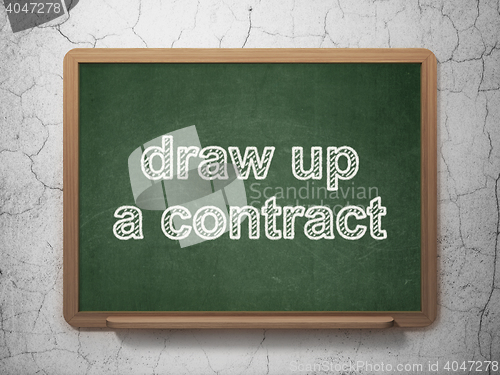 Image of Law concept: Draw up A contract on chalkboard background