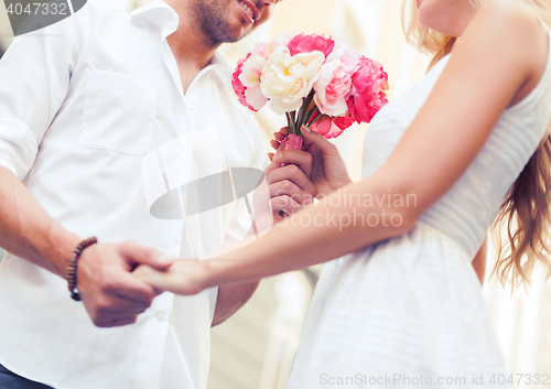 Image of couple with flowers in the city