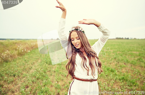 Image of smiling young hippie woman on cereal field