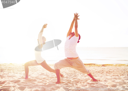 Image of couple making yoga exercises outdoors