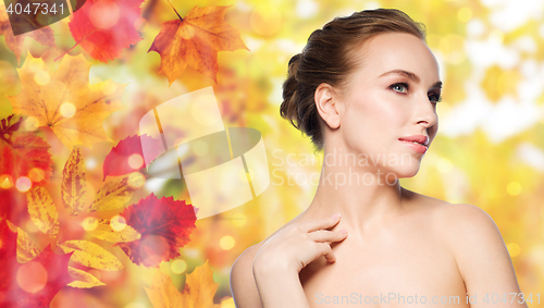 Image of beautiful young woman touching her neck