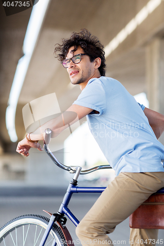 Image of young hipster man riding fixed gear bike