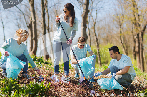 Image of volunteers with garbage bags cleaning park area