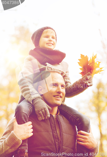 Image of happy family having fun in autumn park