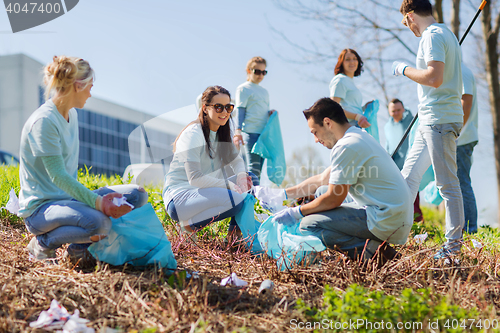 Image of volunteers with garbage bags cleaning park area