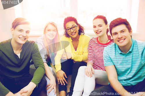 Image of five smiling teenagers having fun at home