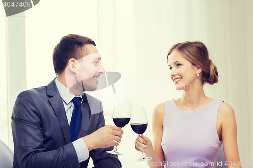 Image of young couple with glasses of wine at restaurant