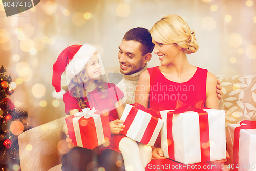 Image of smiling family holding many gift boxes