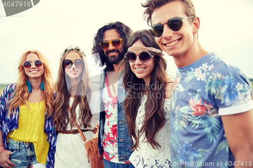 Image of smiling young hippie friends outdoors