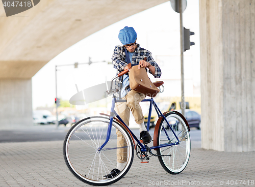 Image of hipster man with shoulder bag on fixed gear bike