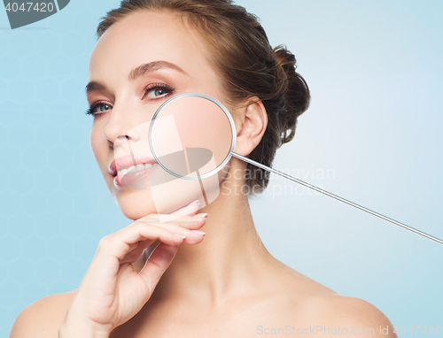 Image of beautiful young woman touching her face