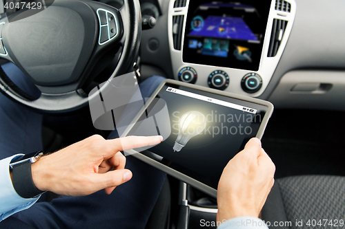 Image of close up of man with tablet pc in car