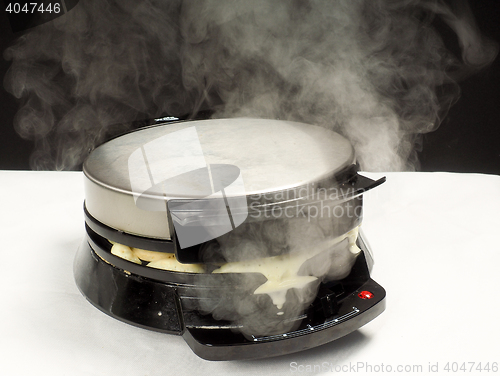 Image of Making of fresh steaming hot waffles