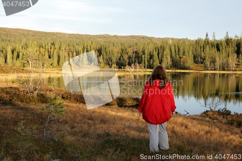 Image of Woman standing by a tarn
