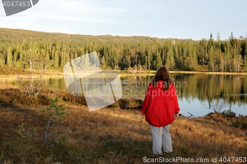 Image of Woman standing by a tarn