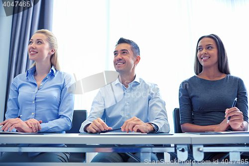 Image of smiling business people meeting in office